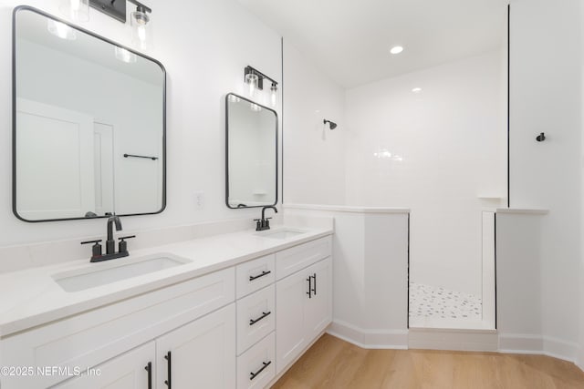 1861 Openwoods Rd, Middleburg, FL 32068 - bathroom featuring walk in shower, double vanity, wood finished floors, and recessed lighting