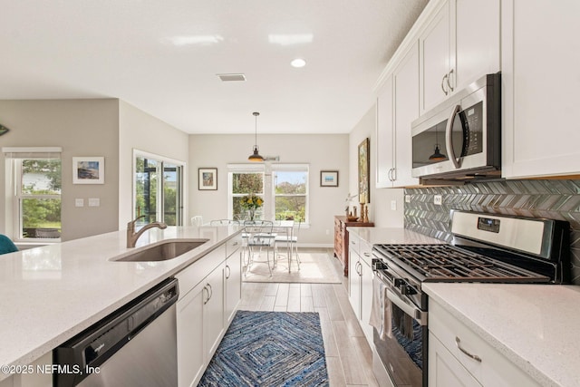 148 Ancient Island Dr, Saint Augustine, FL 32080 - kitchen with appliances with stainless steel finishes, white cabinetry, plenty of natural light, and recessed lighting
