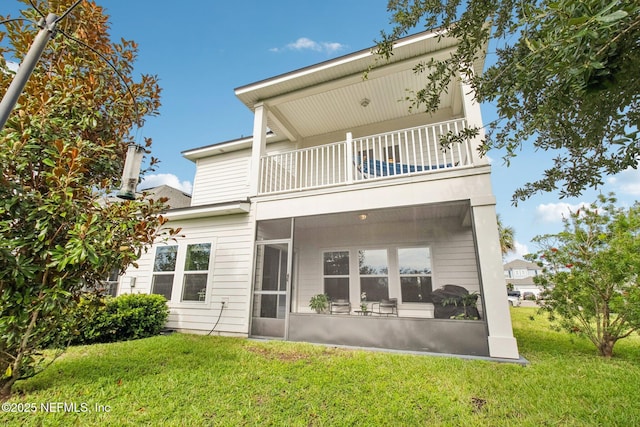 148 Ancient Island Dr, Saint Augustine, FL 32080 - back of house featuring a balcony, a sunroom, and a lawn