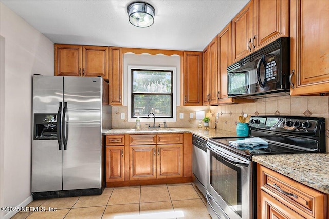 455 Aiken Rd, Jacksonville, FL 32216 - kitchen featuring appliances with stainless steel finishes, brown cabinetry, and decorative backsplash