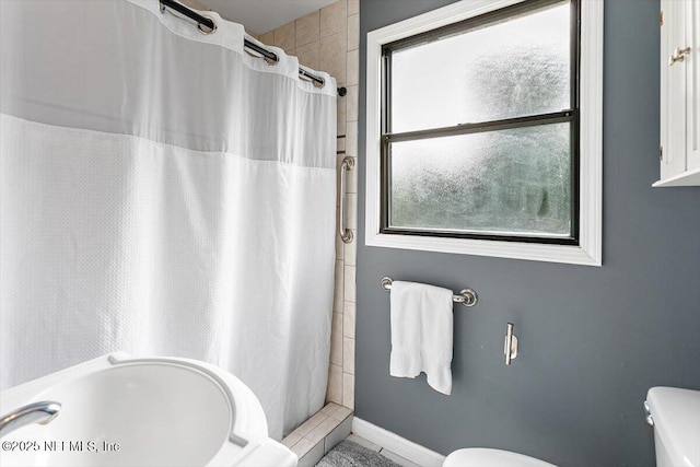 455 Aiken Rd, Jacksonville, FL 32216 - bathroom with toilet and a shower with shower curtain