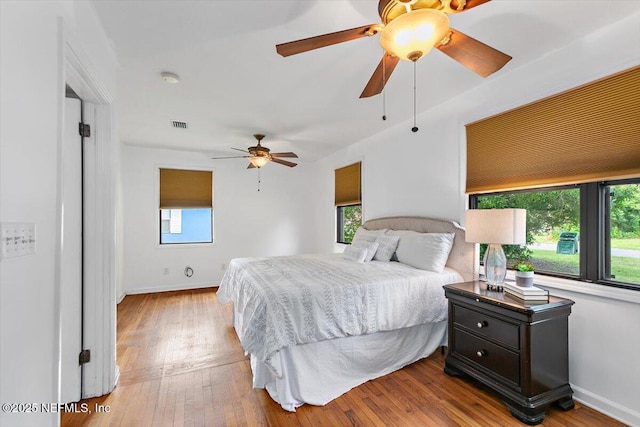 455 Aiken Rd, Jacksonville, FL 32216 - bedroom with multiple windows, light wood-type flooring, and ceiling fan