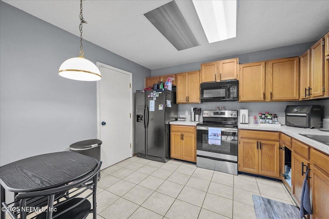 7632 Rain Forest Dr W, Jacksonville, FL 32277 - kitchen with black appliances, light countertops, decorative light fixtures, and light tile patterned floors