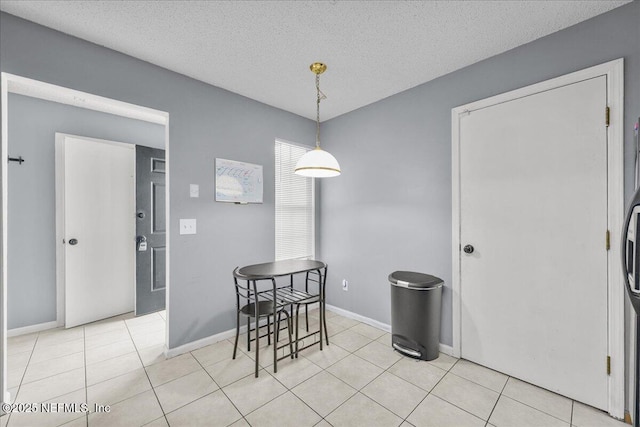 7632 Rain Forest Dr W, Jacksonville, FL 32277 - dining room featuring light tile patterned floors and a textured ceiling