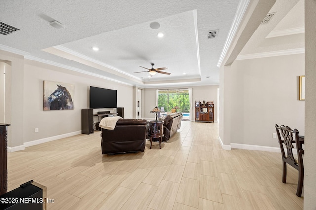 121 Seamount Way, Saint Augustine, FL 32092 - living room with a tray ceiling, ceiling fan, crown molding, a textured ceiling, and light wood-type flooring