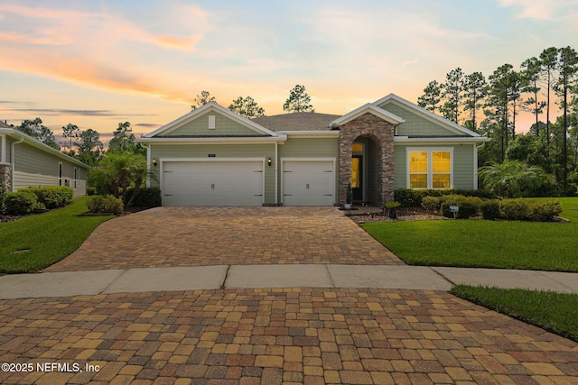 121 Seamount Way, Saint Augustine, FL 32092 - craftsman inspired home featuring decorative driveway, a front yard, a garage, and stone siding