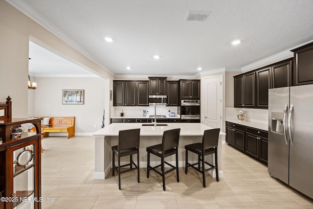 121 Seamount Way, Saint Augustine, FL 32092 - kitchen featuring stainless steel appliances, tasteful backsplash, a kitchen bar, light countertops, and ornamental molding
