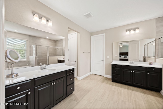 121 Seamount Way, Saint Augustine, FL 32092 - full bathroom featuring two vanities, a stall shower, and ceiling fan