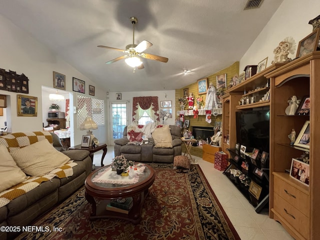1038 Celebrant Dr, Jacksonville, FL 32225 - living room with ceiling fan, lofted ceiling, and a fireplace