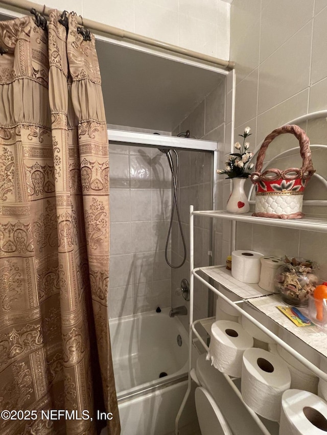 1038 Celebrant Dr, Jacksonville, FL 32225 - bathroom featuring shower / bath combo, tile walls, and decorative backsplash