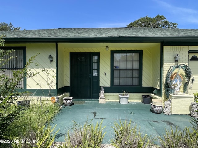 1038 Celebrant Dr, Jacksonville, FL 32225 - property entrance with a shingled roof and a porch