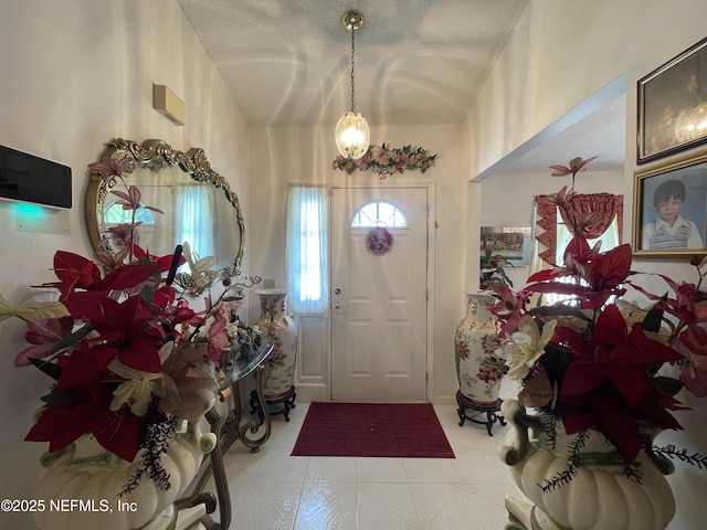1038 Celebrant Dr, Jacksonville, FL 32225 - foyer entrance with lofted ceiling and a textured ceiling