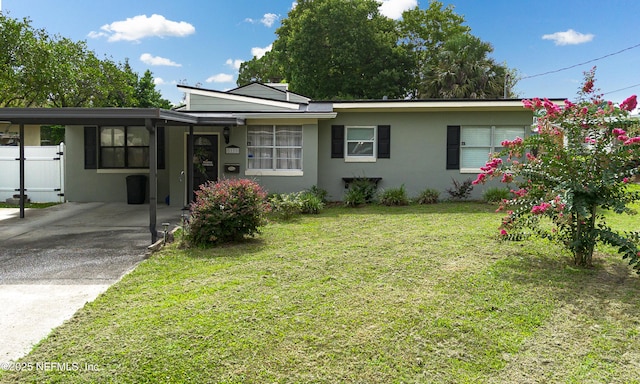 5110 Janice Cir E, Jacksonville, FL 32210 - ranch-style house with a carport, stucco siding, a front yard, and concrete driveway