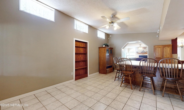 5110 Janice Cir E, Jacksonville, FL 32210 - dining area featuring ceiling fan, a textured ceiling, arched walkways, built in features, and light tile patterned flooring