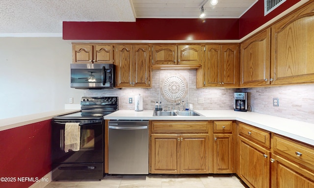 5110 Janice Cir E, Jacksonville, FL 32210 - kitchen featuring stainless steel appliances, light countertops, decorative backsplash, brown cabinetry, and crown molding