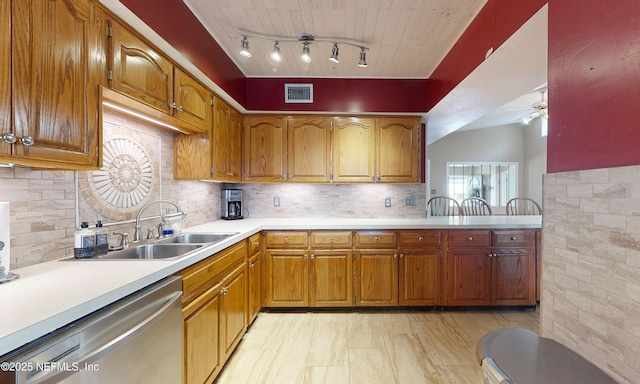 5110 Janice Cir E, Jacksonville, FL 32210 - kitchen with dishwasher, light countertops, brown cabinets, ceiling fan, and track lighting