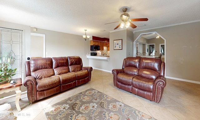 5110 Janice Cir E, Jacksonville, FL 32210 - living area with a ceiling fan, light tile patterned floors, a textured ceiling, arched walkways, and crown molding