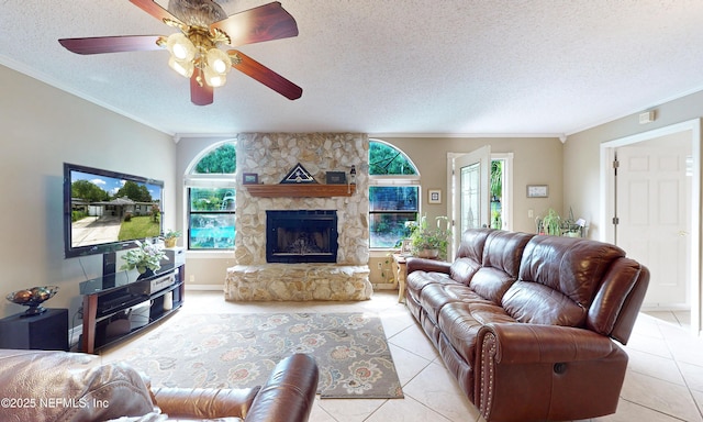 5110 Janice Cir E, Jacksonville, FL 32210 - living room with a textured ceiling, crown molding, light tile patterned floors, a fireplace, and ceiling fan