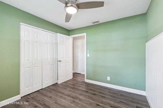 3349 Gilmore St, Jacksonville, FL 32205 - unfurnished bedroom with dark wood-type flooring, a closet, and a ceiling fan