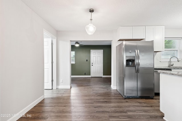 3349 Gilmore St, Jacksonville, FL 32205 - kitchen featuring stainless steel appliances, white cabinetry, dark wood-style floors, pendant lighting, and light stone countertops