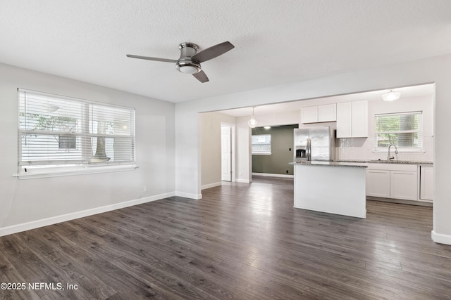 3349 Gilmore St, Jacksonville, FL 32205 - kitchen with stainless steel fridge with ice dispenser, a ceiling fan, open floor plan, white cabinets, and dark wood-style floors