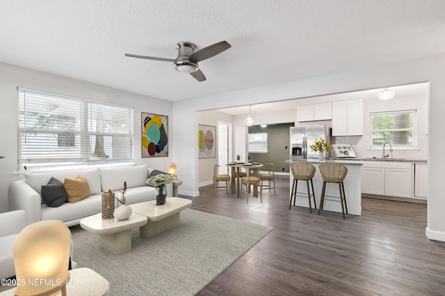 3349 Gilmore St, Jacksonville, FL 32205 - living area featuring ceiling fan, dark wood-style floors, and a textured ceiling