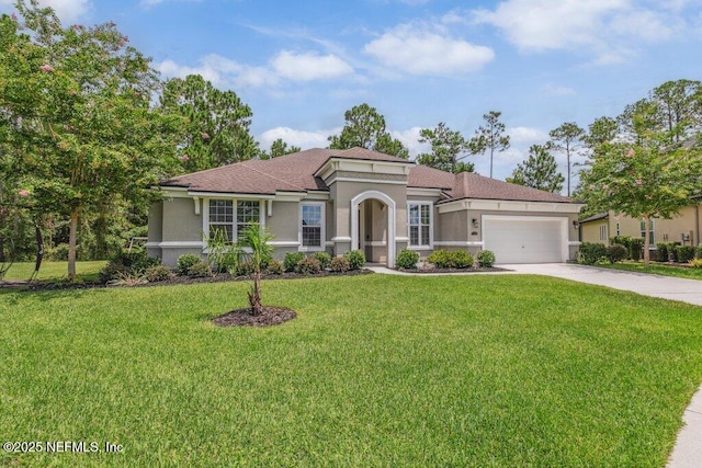 1103 Orchard Oriole Pl, Middleburg, FL 32068 - mediterranean / spanish-style home featuring stucco siding, a garage, concrete driveway, and a front yard