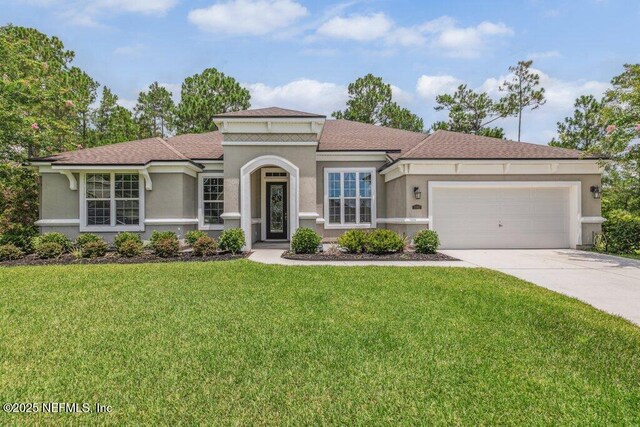 1103 Orchard Oriole Pl, Middleburg, FL 32068 - mediterranean / spanish house with a garage, concrete driveway, stucco siding, and a front yard