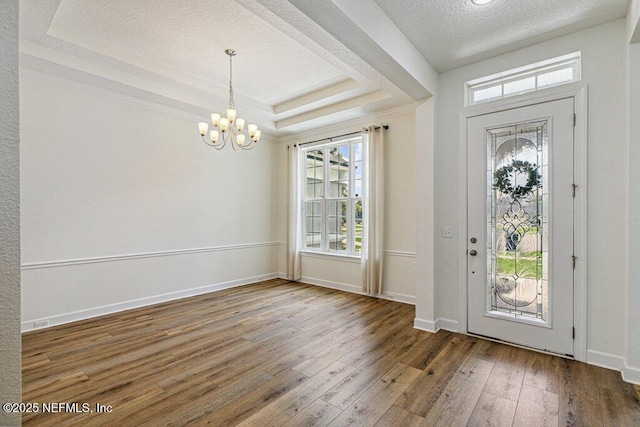 1103 Orchard Oriole Pl, Middleburg, FL 32068 - entrance foyer with a chandelier, a tray ceiling, hardwood / wood-style flooring, and a textured ceiling