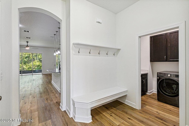 1103 Orchard Oriole Pl, Middleburg, FL 32068 - mudroom with washer / dryer, arched walkways, and light wood-style flooring