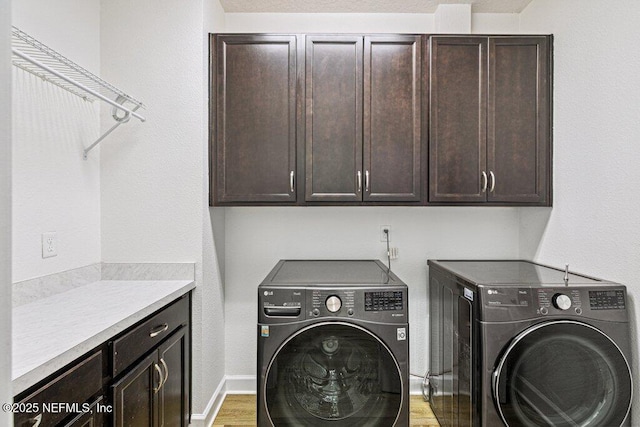 1103 Orchard Oriole Pl, Middleburg, FL 32068 - washroom featuring washing machine and clothes dryer, cabinet space, and light wood-style floors