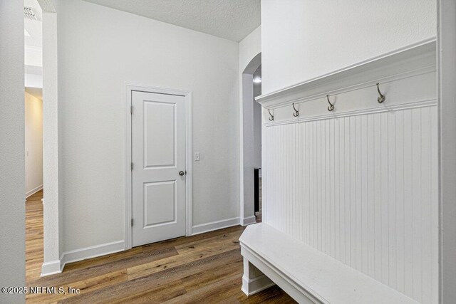1103 Orchard Oriole Pl, Middleburg, FL 32068 - mudroom featuring wood finished floors and arched walkways