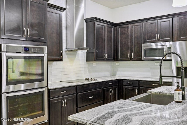 1103 Orchard Oriole Pl, Middleburg, FL 32068 - kitchen with stainless steel appliances, wall chimney exhaust hood, and light stone countertops