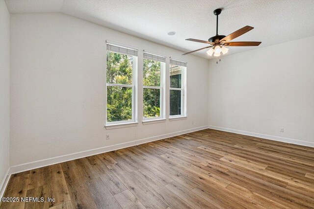 1103 Orchard Oriole Pl, Middleburg, FL 32068 - spare room featuring a ceiling fan, wood finished floors, lofted ceiling, and a textured ceiling