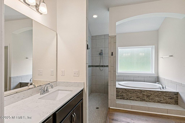 1103 Orchard Oriole Pl, Middleburg, FL 32068 - full bath featuring a garden tub, vanity, tiled shower, and wood finished floors