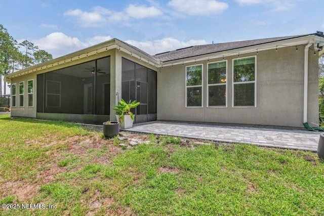1103 Orchard Oriole Pl, Middleburg, FL 32068 - back of property with a sunroom, a lawn, ceiling fan, stucco siding, and a patio area