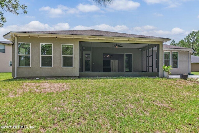 1103 Orchard Oriole Pl, Middleburg, FL 32068 - back of property featuring a sunroom, a lawn, a ceiling fan, and stucco siding