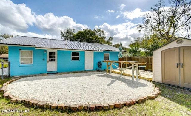 1922 Locust Ave, Palatka, FL 32177 - back of house featuring a storage unit, a patio area, and a metal roof