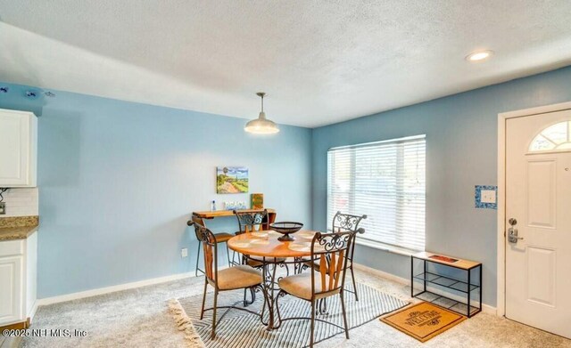 1922 Locust Ave, Palatka, FL 32177 - dining room with light carpet and a textured ceiling