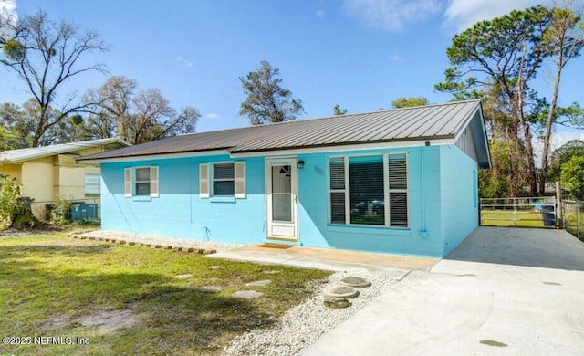1922 Locust Ave, Palatka, FL 32177 - view of front of home featuring concrete block siding, driveway, and a metal roof