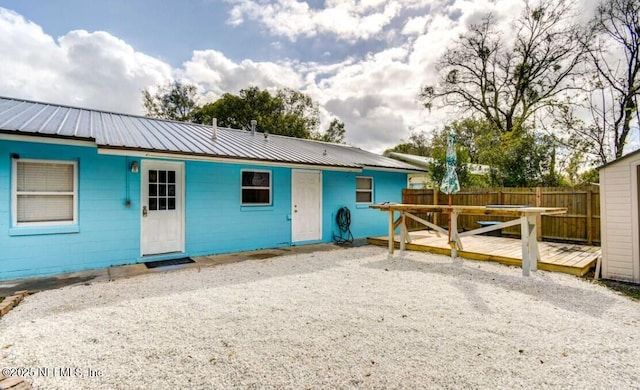 1922 Locust Ave, Palatka, FL 32177 - back of house featuring a wooden deck and a metal roof