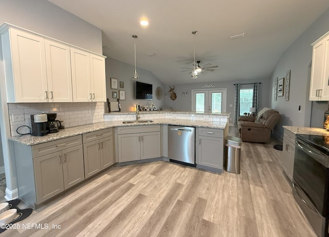 51321 Bloomington Way, Callahan, FL 32011 - kitchen featuring stainless steel appliances, a peninsula, open floor plan, vaulted ceiling, and tasteful backsplash