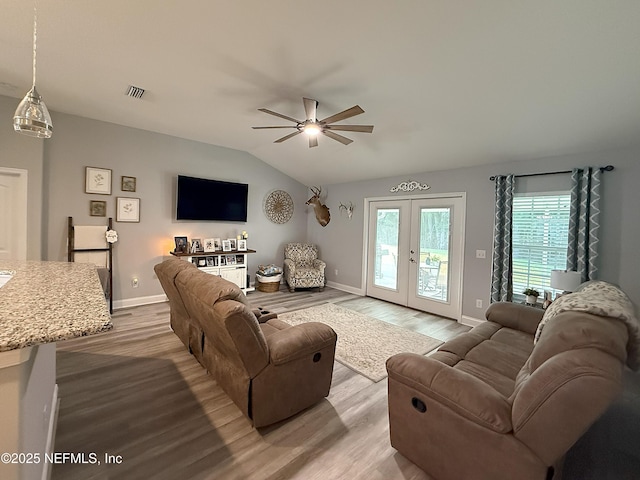 51321 Bloomington Way, Callahan, FL 32011 - living room featuring vaulted ceiling, ceiling fan, french doors, and wood finished floors