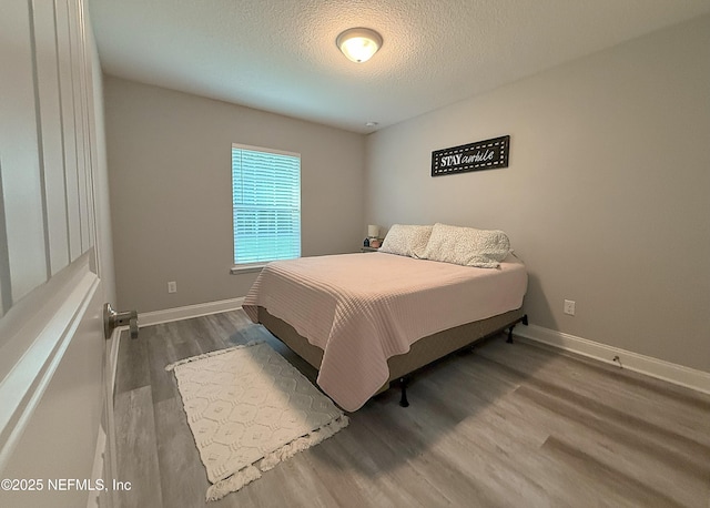 51321 Bloomington Way, Callahan, FL 32011 - bedroom featuring wood finished floors and a textured ceiling
