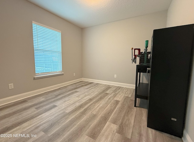 51321 Bloomington Way, Callahan, FL 32011 - spare room with wood finished floors and a textured ceiling