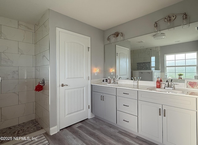 51321 Bloomington Way, Callahan, FL 32011 - bathroom featuring double vanity, walk in shower, and wood finished floors