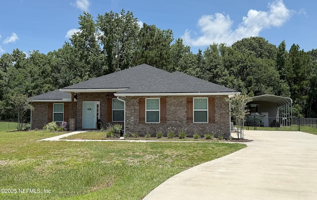 51321 Bloomington Way, Callahan, FL 32011 - view of front of house with a detached carport, concrete driveway, brick siding, and a shingled roof