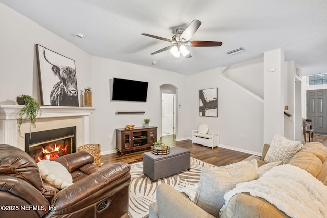 1020 Candlebark Dr, Jacksonville, FL 32225 - living room with arched walkways, ceiling fan, wood finished floors, and a glass covered fireplace