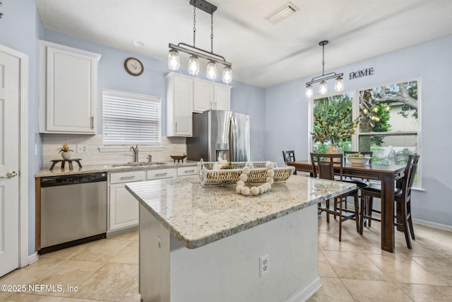 1020 Candlebark Dr, Jacksonville, FL 32225 - kitchen featuring appliances with stainless steel finishes, healthy amount of natural light, and white cabinets