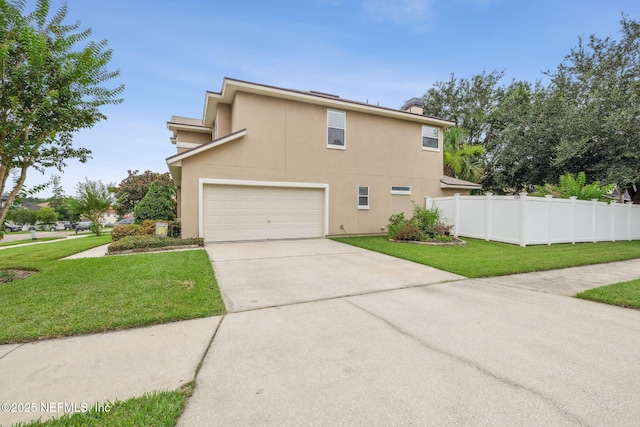 1020 Candlebark Dr, Jacksonville, FL 32225 - view of property exterior featuring driveway, stucco siding, and an attached garage